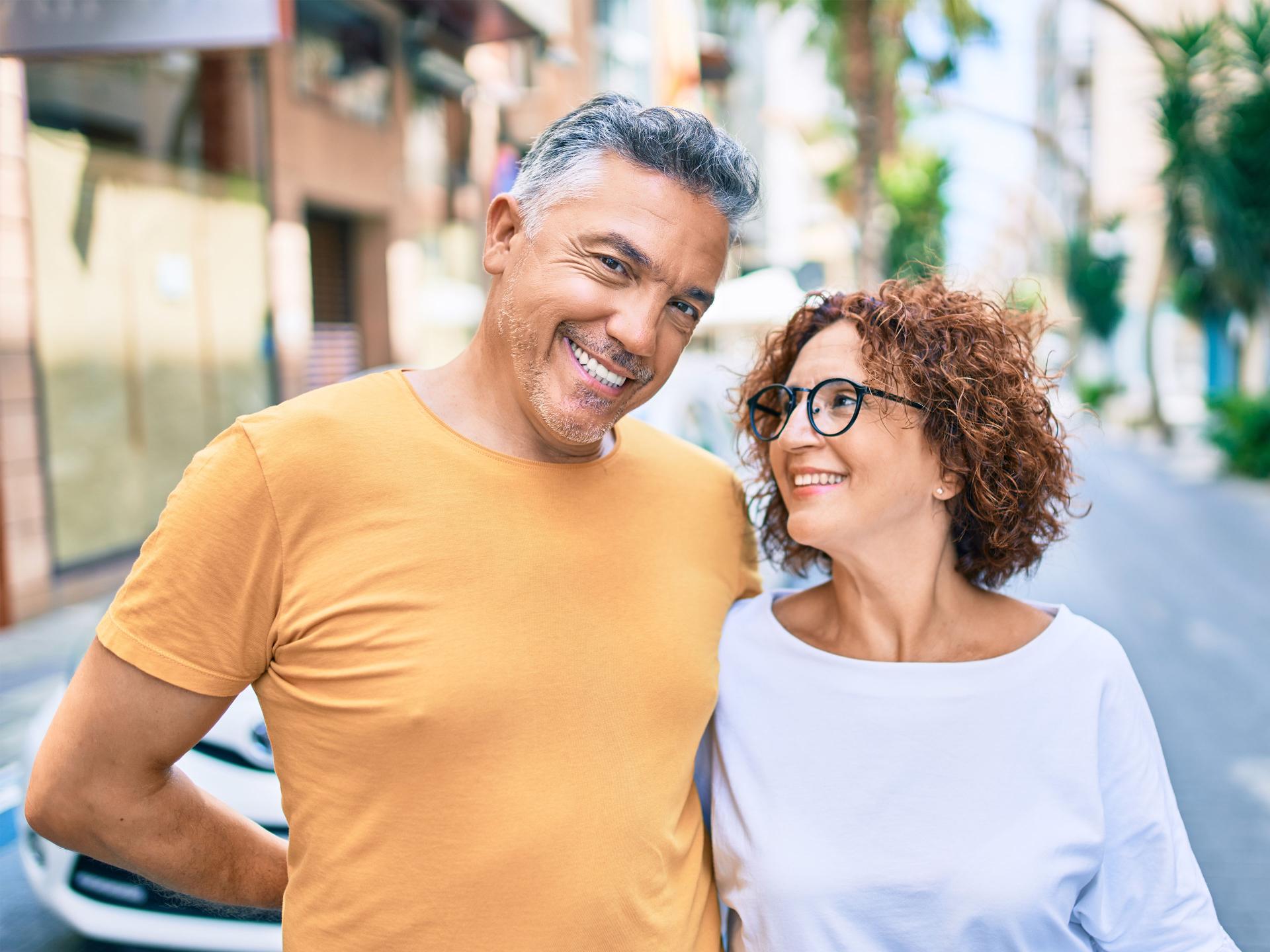 Middle age couple smiling happy standing at street of city